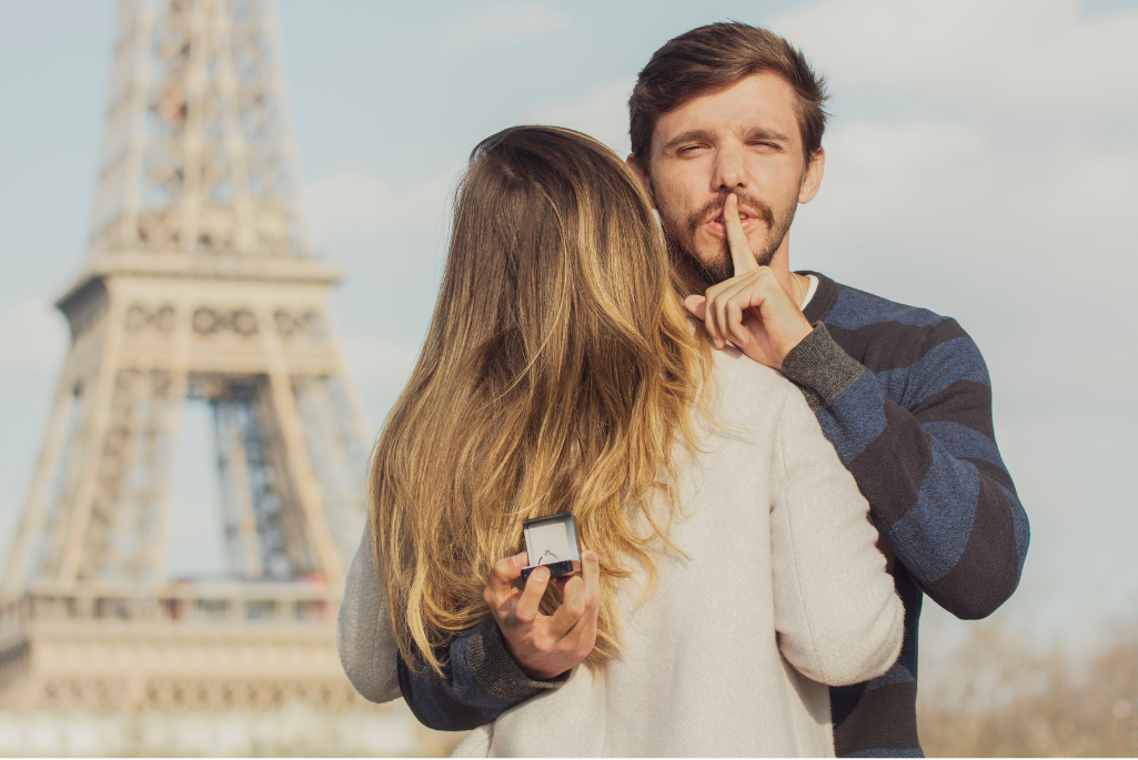 Un homme faisant une demande en mariage devant la Tour Eiffel.